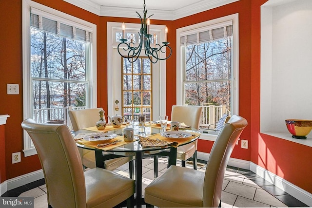 tiled dining area with a chandelier, crown molding, and baseboards