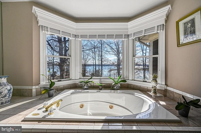 bathroom featuring a whirlpool tub and a water view