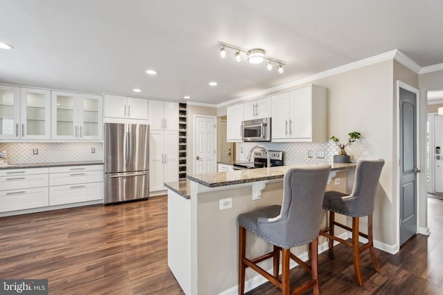6215 Hot Spring Ln, Fredericksburg, VA 22407 - kitchen with appliances with stainless steel finishes, ornamental molding, stone countertops, tasteful backsplash, and white cabinets