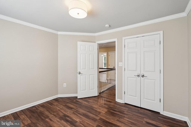 6215 Hot Spring Ln, Fredericksburg, VA 22407 - unfurnished bedroom with dark wood-style flooring, crown molding, baseboards, and a closet