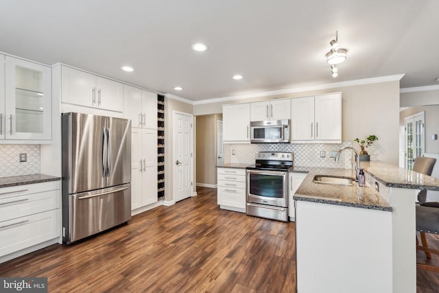 6215 Hot Spring Ln, Fredericksburg, VA 22407 - kitchen featuring appliances with stainless steel finishes, a sink, a peninsula, ornamental molding, and white cabinets