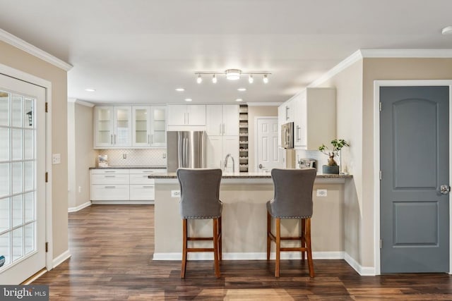 6215 Hot Spring Ln, Fredericksburg, VA 22407 - kitchen featuring appliances with stainless steel finishes, a peninsula, decorative backsplash, ornamental molding, and glass insert cabinets