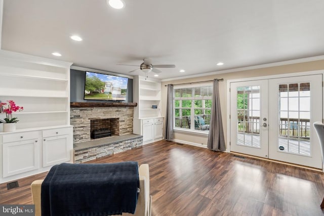6215 Hot Spring Ln, Fredericksburg, VA 22407 - living area with crown molding, a ceiling fan, a stone fireplace, french doors, and dark wood-style floors