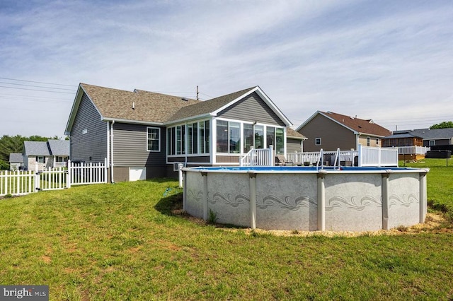 53 Arthur Ln, Luray, VA 22835 - rear view of property with a sunroom, an outdoor pool, and roof with shingles