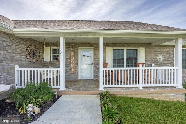 53 Arthur Ln, Luray, VA 22835 - doorway to property featuring covered porch, brick siding, and a shingled roof