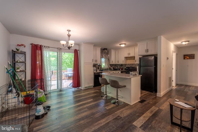 6506 Plantation Forest Dr, Spotsylvania, VA 22553 - kitchen featuring black appliances, dark wood-style flooring, white cabinetry, a chandelier, and a kitchen breakfast bar