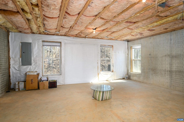 basement with brick wall and electric panel