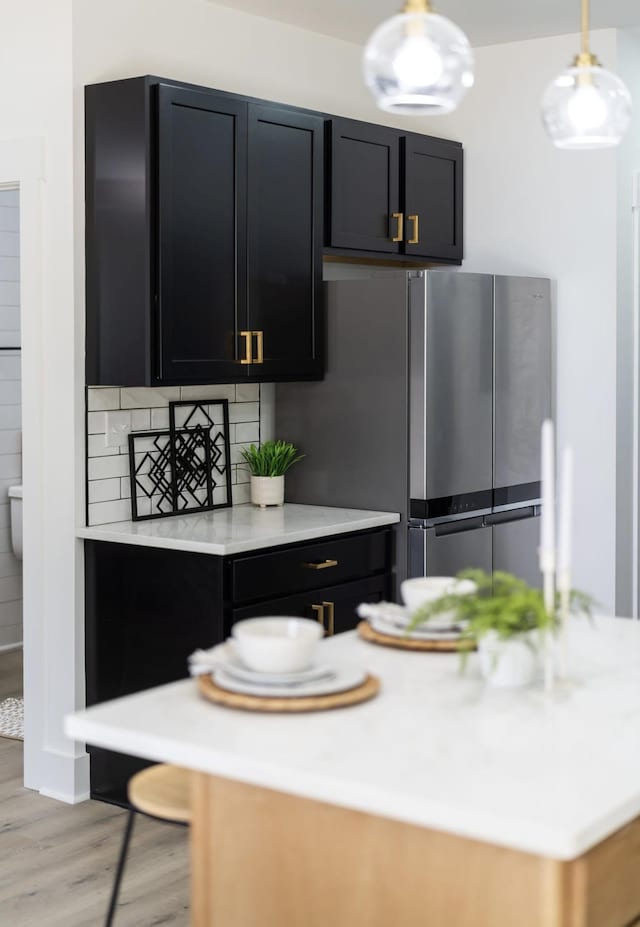 9 Walnut St, Fishersville, VA 22939 - kitchen with light countertops, freestanding refrigerator, light wood-style flooring, and dark cabinetry