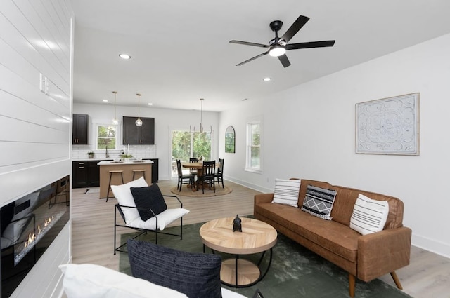 9 Walnut St, Fishersville, VA 22939 - living area featuring light wood-style floors, recessed lighting, a ceiling fan, baseboards, and a glass covered fireplace