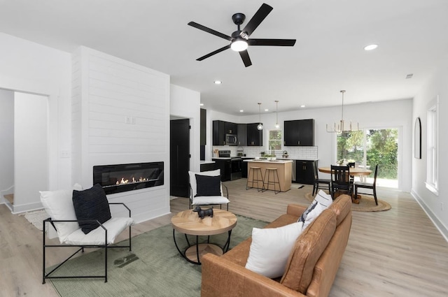 9 Walnut St, Fishersville, VA 22939 - living room with light wood-style floors, a fireplace, ceiling fan, baseboards, and recessed lighting