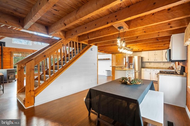 248 Wintergreen Dr, Luray, VA 22835 - dining space featuring dark wood-type flooring, wooden ceiling, stairway, beamed ceiling, and baseboards