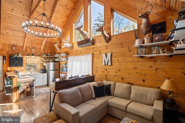 248 Wintergreen Dr, Luray, VA 22835 - living room with high vaulted ceiling, light wood-type flooring, wood walls, wooden ceiling, and a chandelier