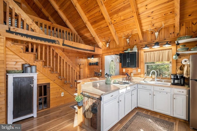 248 Wintergreen Dr, Luray, VA 22835 - kitchen featuring wooden ceiling, wooden walls, light countertops, and beam ceiling