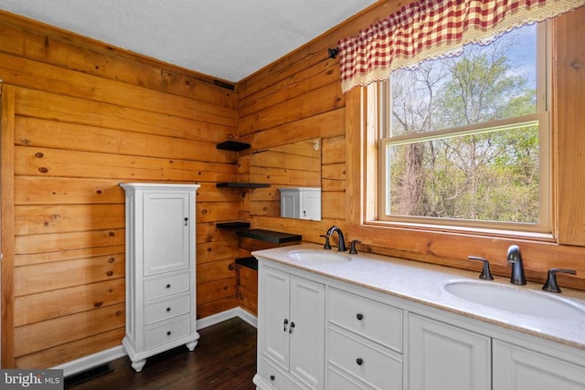 248 Wintergreen Dr, Luray, VA 22835 - kitchen with white cabinetry, wooden walls, dark wood-style flooring, and a sink