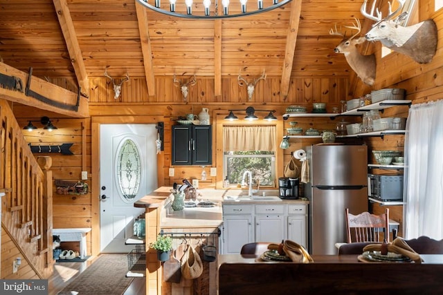 248 Wintergreen Dr, Luray, VA 22835 - kitchen with wooden ceiling, freestanding refrigerator, wood walls, and lofted ceiling with beams