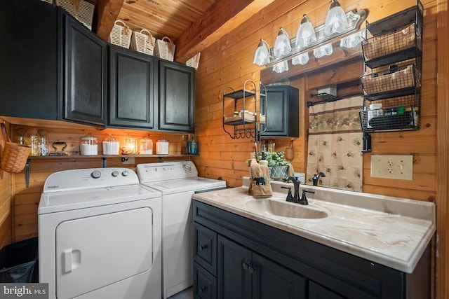 248 Wintergreen Dr, Luray, VA 22835 - washroom featuring a sink, cabinet space, washer and dryer, wooden ceiling, and wooden walls