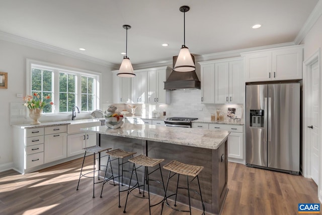 33 Ashlin Cv, Charlottesville, VA 22901 - kitchen with wood finished floors, a center island, custom range hood, and appliances with stainless steel finishes