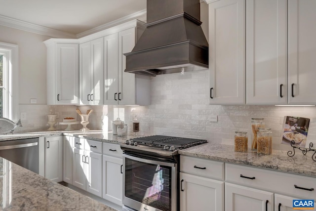 33 Ashlin Cv, Charlottesville, VA 22901 - kitchen with decorative backsplash, white cabinets, crown molding, appliances with stainless steel finishes, and premium range hood