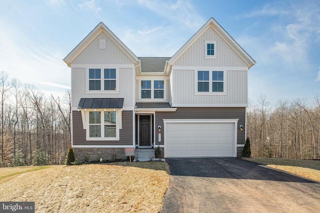view of front of home with asphalt driveway, an attached garage, a standing seam roof, metal roof, and a shingled roof