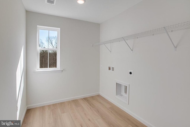 clothes washing area with electric dryer hookup, light wood-style flooring, baseboards, washer hookup, and recessed lighting