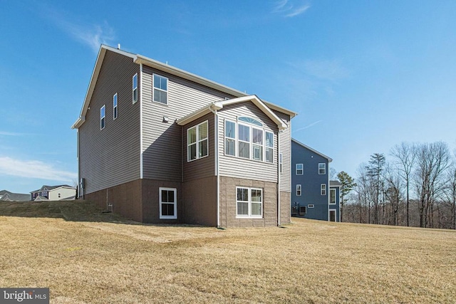 back of property featuring a lawn