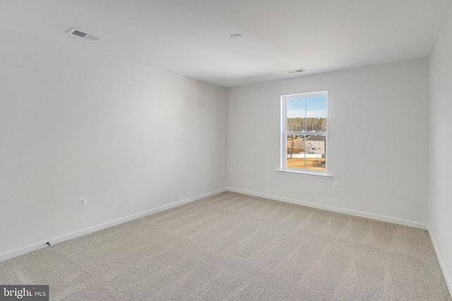 carpeted spare room with baseboards