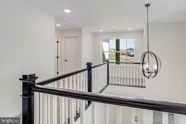 stairs with a chandelier, recessed lighting, and baseboards