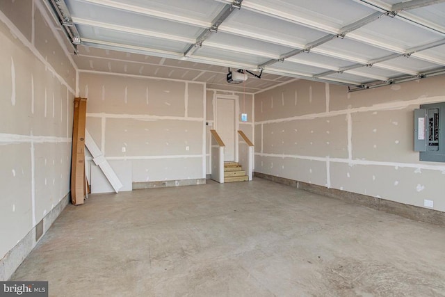 garage featuring electric panel and a garage door opener