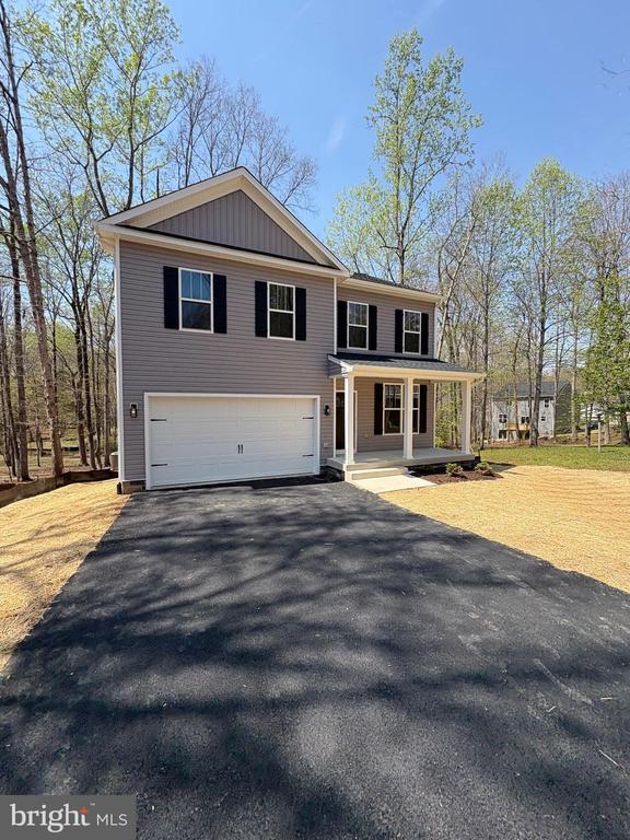 406 Westover Pkwy, Locust Grove, VA 22508 - view of front of home featuring a porch, asphalt driveway, and a garage