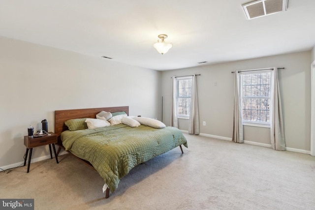 bedroom with light carpet, baseboards, and visible vents