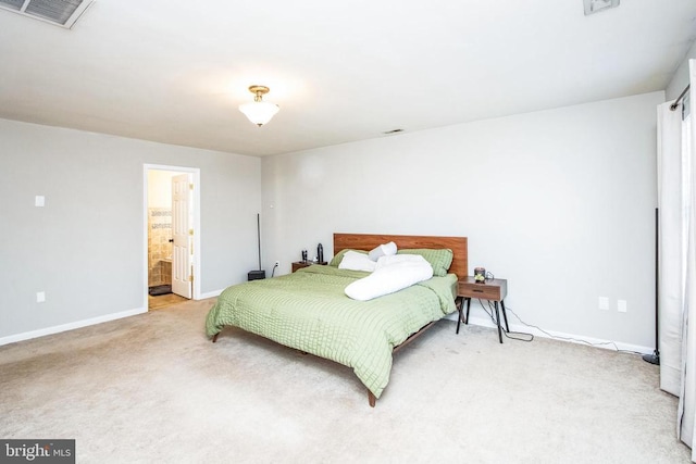 bedroom featuring baseboards, light carpet, connected bathroom, and visible vents