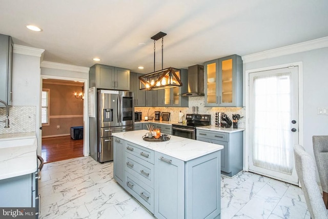 kitchen featuring recessed lighting, a chandelier, crown molding, wall chimney range hood, and stainless steel appliances