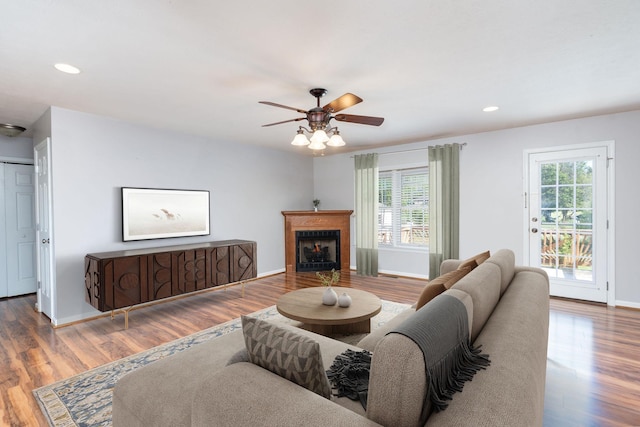 living area featuring plenty of natural light, ceiling fan, wood finished floors, and recessed lighting