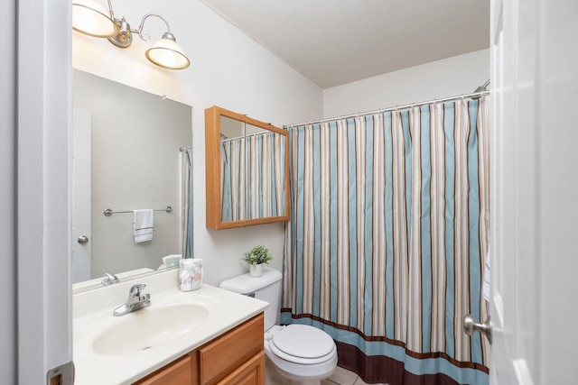 full bathroom with toilet, vanity, and curtained shower