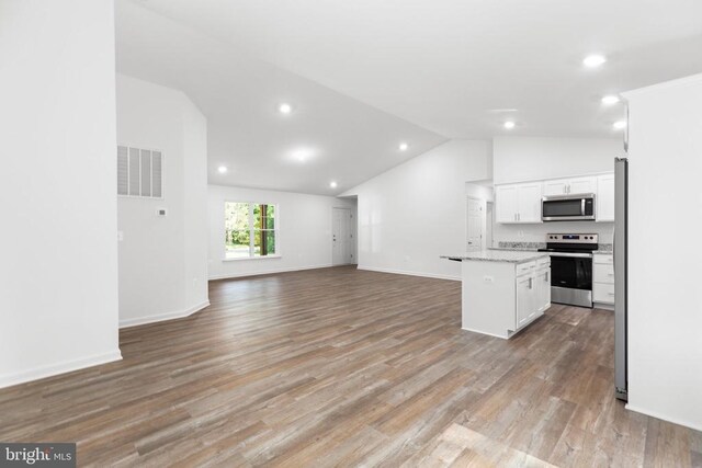Pine Harbour Dr, Mineral, VA 23117 - kitchen with stainless steel appliances, vaulted ceiling, open floor plan, white cabinets, and a center island