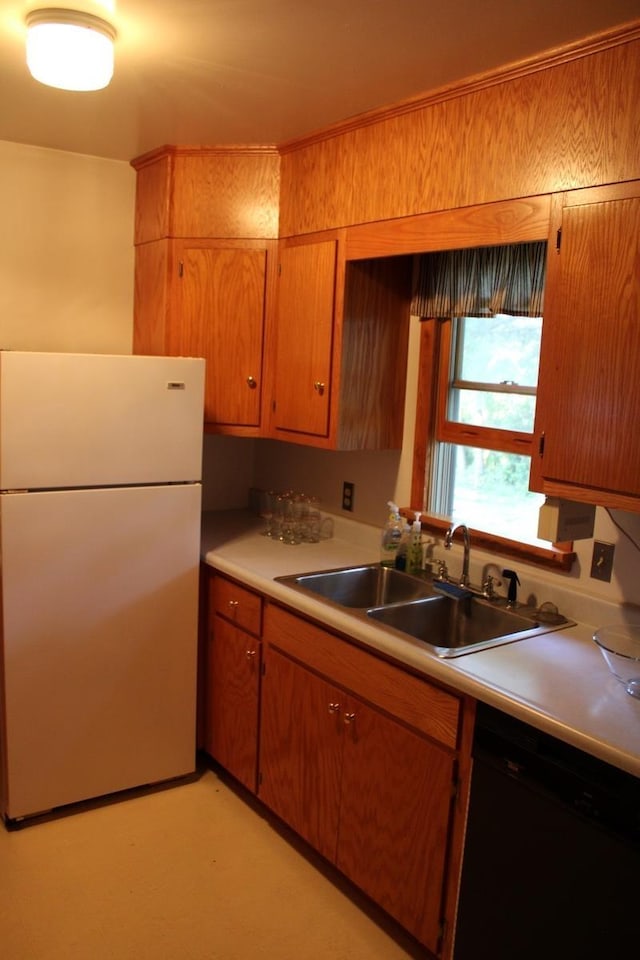 581 Oak Grove Church Rd, Waynesboro, VA 22980 - kitchen with freestanding refrigerator, dishwasher, a sink, light countertops, and brown cabinets