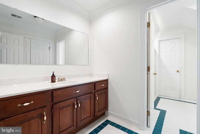  - bathroom featuring vanity, baseboards, tile patterned floors, and ornamental molding