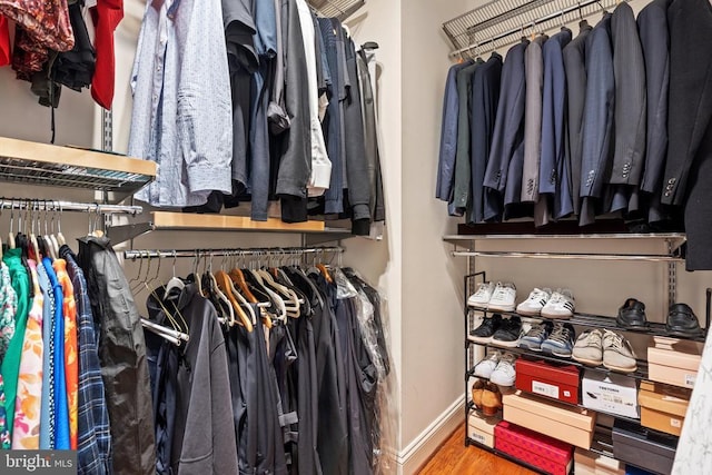  - spacious closet with wood finished floors