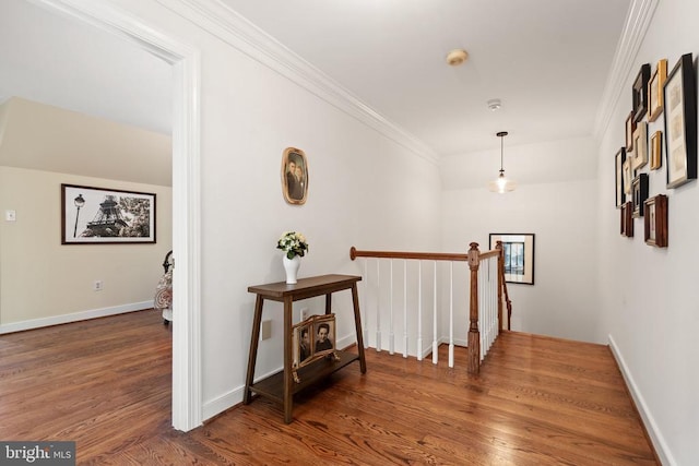  - hall with crown molding, wood finished floors, an upstairs landing, and baseboards