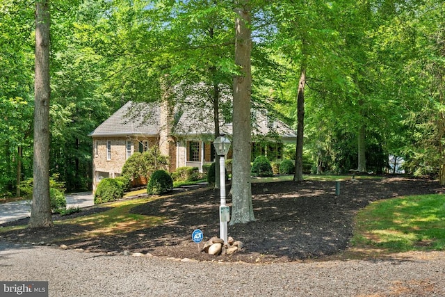  - view of front facade with an attached garage and brick siding