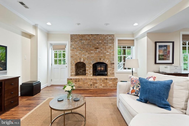 - living room with wood finished floors, plenty of natural light, crown molding, recessed lighting, and baseboards