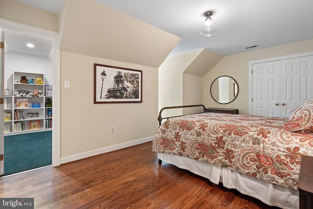  - bedroom featuring wood finished floors, baseboards, a closet, and lofted ceiling