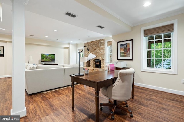  - office featuring crown molding, wood finished floors, baseboards, a brick fireplace, and recessed lighting
