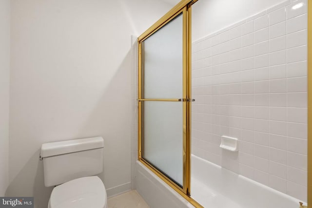  - full bath featuring toilet and shower / bath combination with glass door