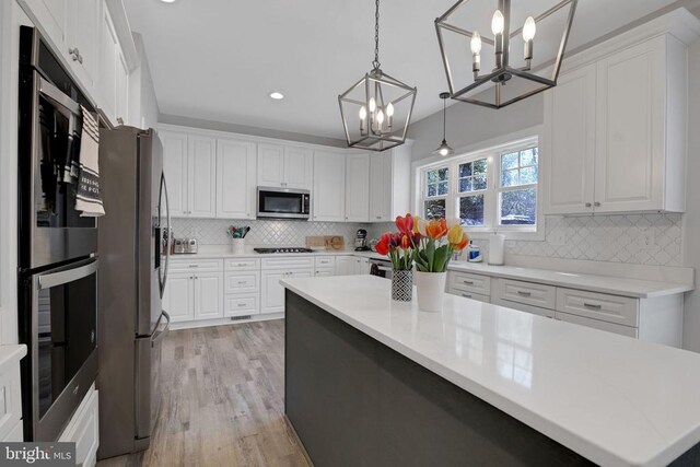 1909 Artillery Ridge Rd, Fredericksburg, VA 22408 - kitchen with appliances with stainless steel finishes, a chandelier, white cabinets, light countertops, and recessed lighting