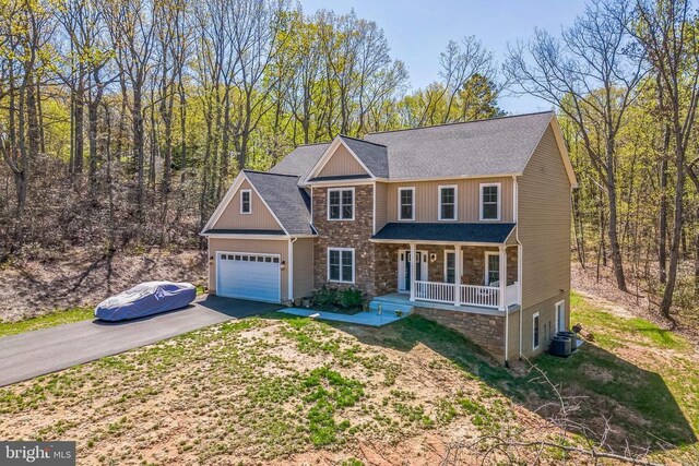1909 Artillery Ridge Rd, Fredericksburg, VA 22408 - view of front facade with a porch, stone siding, driveway, a garage, and roof with shingles