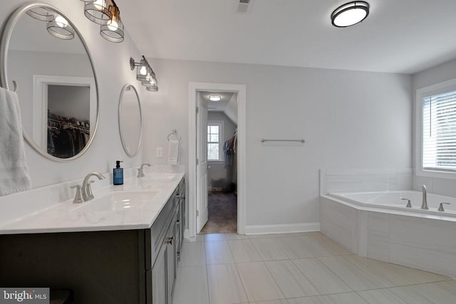 1909 Artillery Ridge Rd, Fredericksburg, VA 22408 - bathroom featuring a bath, double vanity, a walk in closet, tile patterned floors, and baseboards
