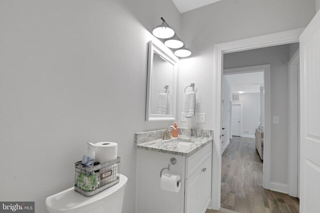 1909 Artillery Ridge Rd, Fredericksburg, VA 22408 - half bathroom with wood finished floors, vanity, baseboards, and toilet