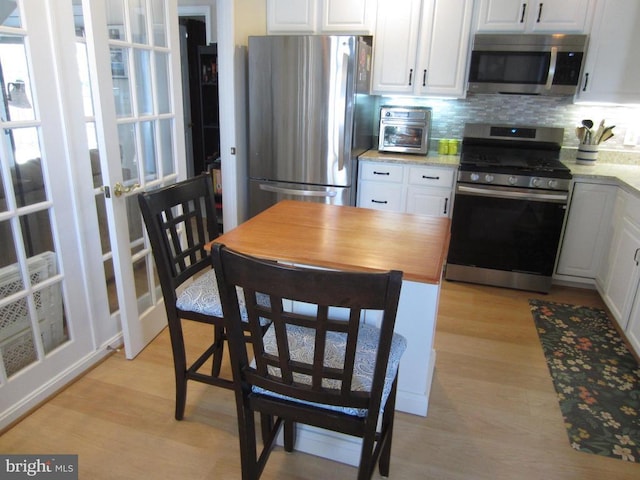 11200 Scottwood Ln N, Fredericksburg, VA 22407 - kitchen featuring stainless steel appliances, light wood-style flooring, and white cabinets