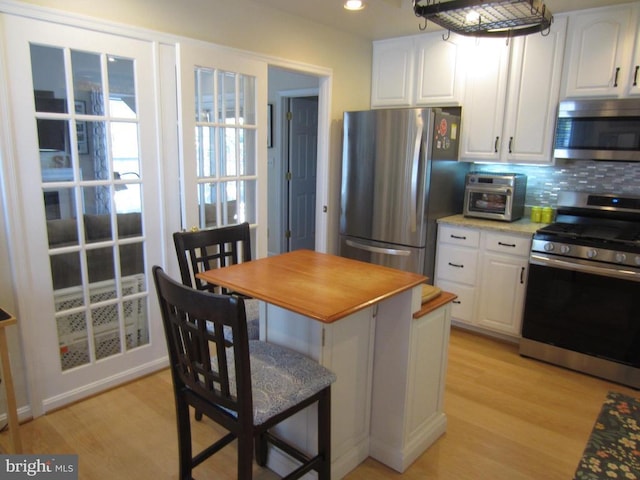 11200 Scottwood Ln N, Fredericksburg, VA 22407 - kitchen featuring appliances with stainless steel finishes, light wood-style floors, white cabinetry, and recessed lighting